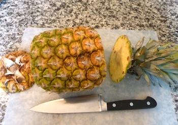 Picture of ripe pineapple with top and bottom sliced off / www.super-seafood-recipes.com